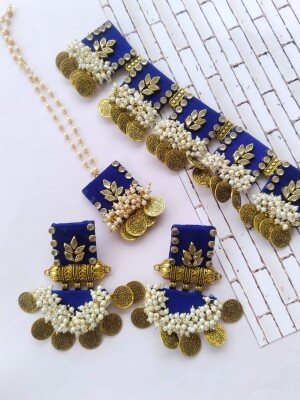 Regal blue kundan necklace, tika, and earrings set with silver and golden beads