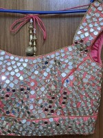 A beautiful blush pink lehenga with contrast pista color dupatta,The intricate mirror work on the blouse and dupatta
