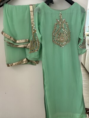 Neon green, georgette suit with golden mirror Work on the front and back .