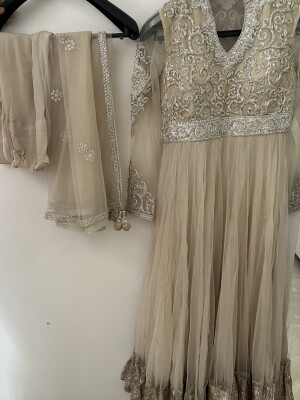 Pretty beige net Anarkali suit with silver embroidery And an embroidered net dupatta