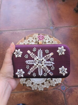 Embroidered clutch in different colours by Ava Embroidery