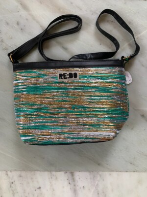 HETI Sling Purse- a true embodiment of fashion, functionality, and sophistication.