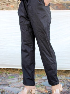 Black Padmraga Pants, styled with an elasticized waist