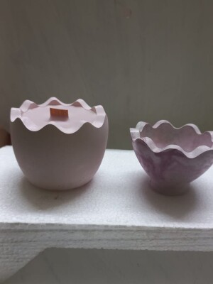 Decorative concrete egg shaped container filled with soya wax infused with oudh fragrance