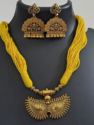 Yellow Cotton thread necklace with antique finish pendant and matching earrings