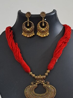 Red beaded thread necklace with oxidized golden pendant